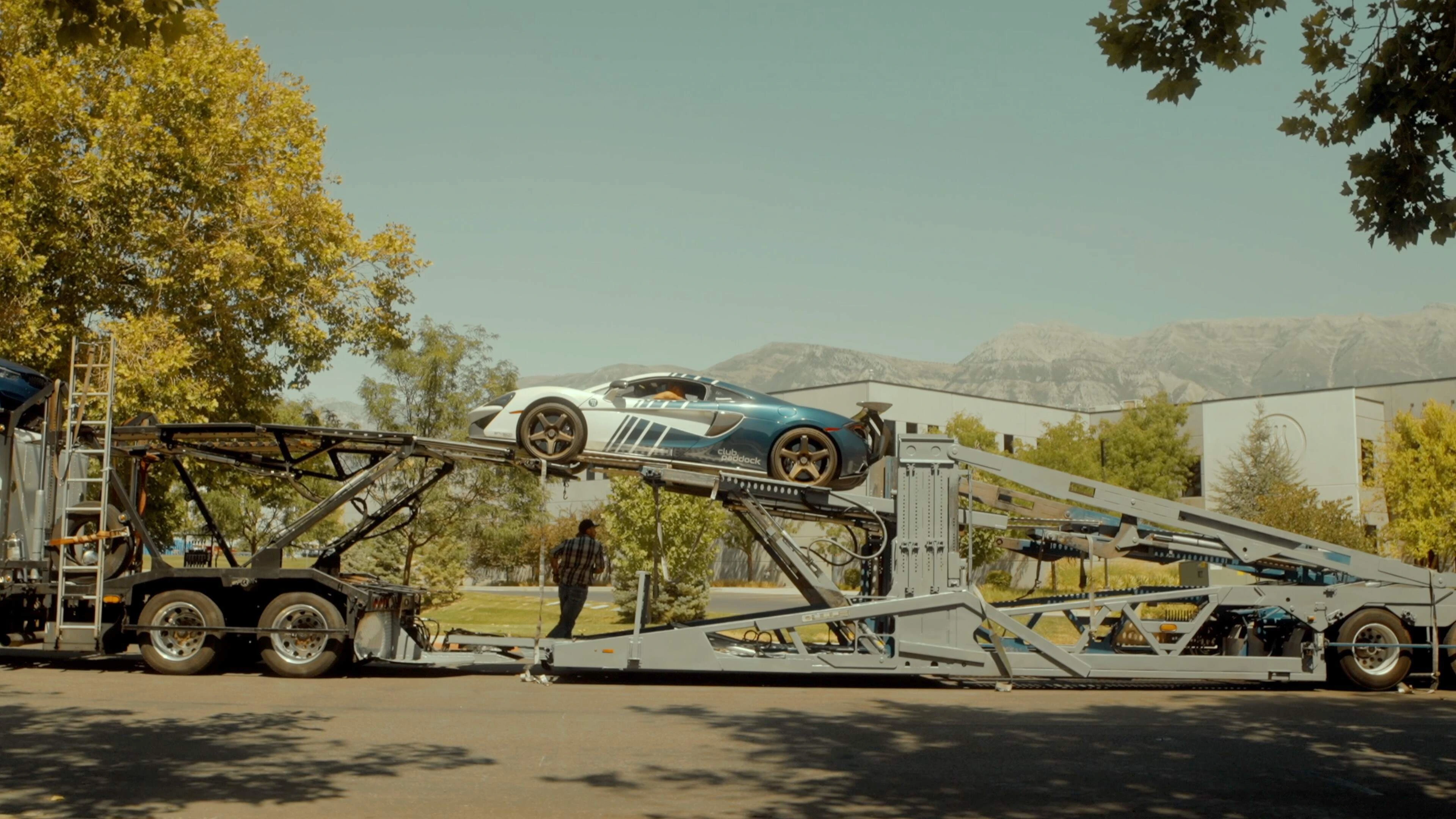 Vehicle loading on a car hauler at sunset